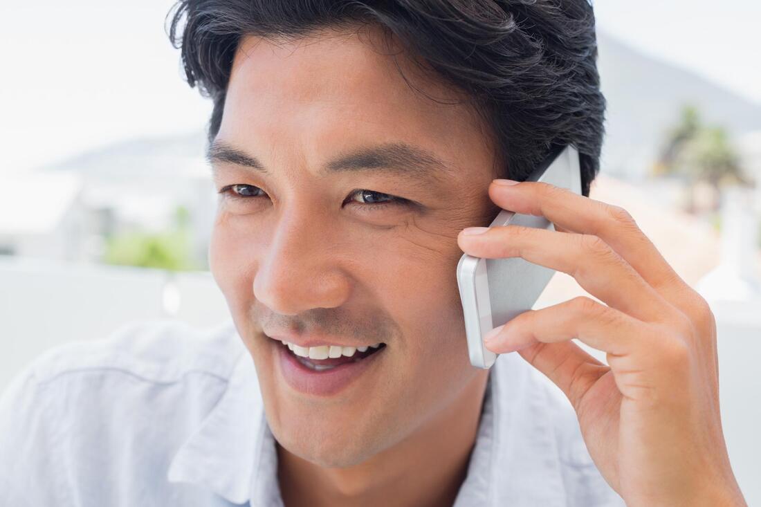 man smile taking phone call